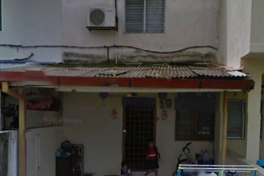 An image found on Google Street View showing a boy and his sister getting ready to leave their house in Taman Usaha Jaya, Selangor. -- PHOTO: THE STAR/ASIA NEWS NETWORK