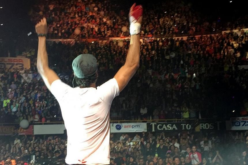 Spanish singer Enrique Iglesias performing on stage with a bloodied T-shirt covering his hand after suffering an accident with a drone on his right hand, during a concert in Tijuana, Mexico on Saturday night (May 30). Iglesias suffered several cuts o