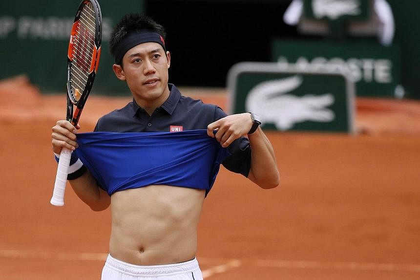 Japan's Kei Nishikori gestures during his match against Russia's Teymuraz Gabashvili during the men's fourth round of the Roland Garros 2015 French Tennis Open in Paris on Sunday (May 31). -- PHOTO: AFP
