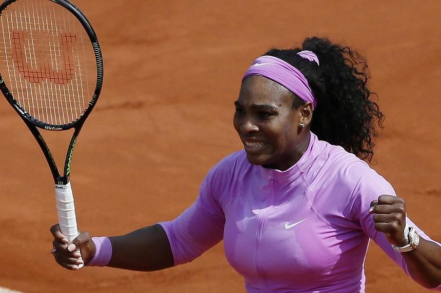 US player Serena Williams celebrates after winning her match against fellow American Sloane Stephens during the women's fourth round of the Roland Garros 2015 French Tennis Open in Paris on Monday (June 1). -- PHOTO: AFP&nbsp;