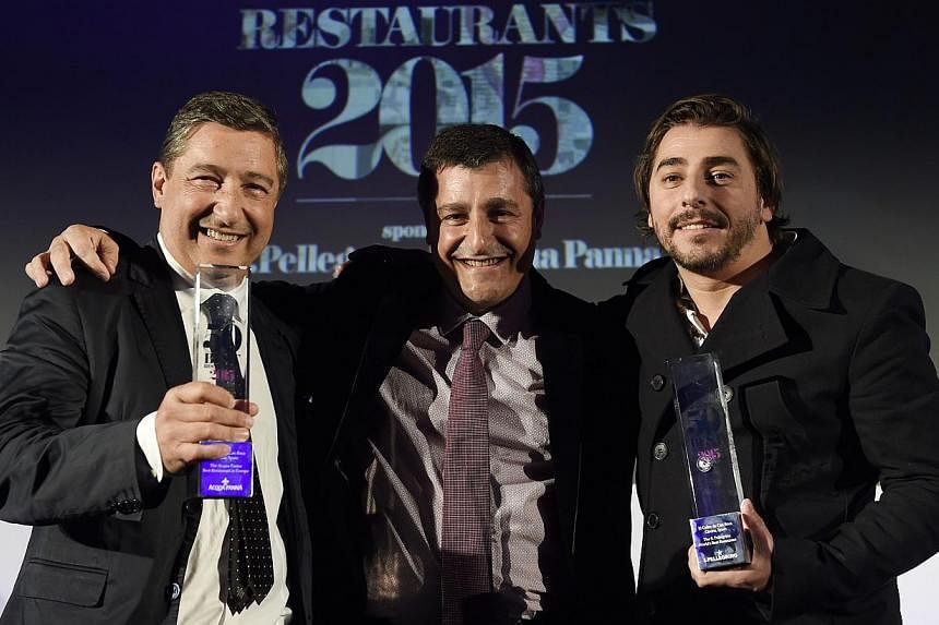 Spanish pastry chef Jordi Roca (right), chef Joan Roca (left) and sommelier Joseph Roca (centre), brothers and owners of the restaurant El Celler de Can Roca in Girona, Spain, smile after winning the best restaurant prize during the ceremony for the 