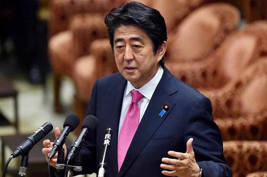 Japanese Prime Minister Shinzo Abe said on Tuesday he would pledge a 26 per cent cut in the country's greenhouse gas emissions, ahead of a global summit on climate change this year. -- PHOTO: AFP