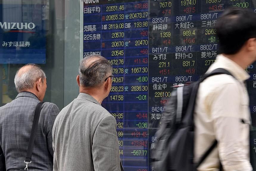 Most Asian stocks advanced as the yen held near a 12-year low against the US dollar after data showed growth in US manufacturing. -- PHOTO: AFP