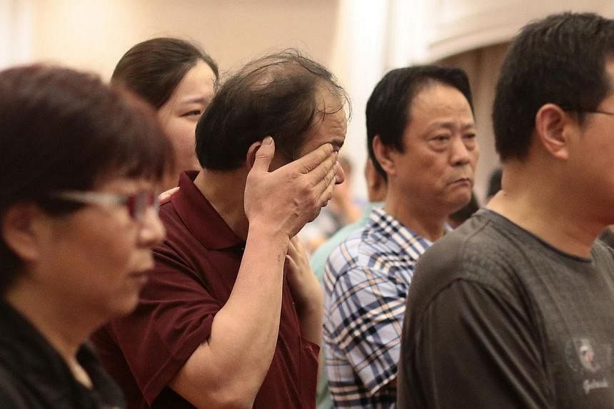 Relatives of passengers on board the Dongfangzhixing or "Eastern Star" which sank en route from Nanjing to Chongqing, react as they wait for information at a hotel in Nanjing, Jiangsu province on June 2, 2015. Family members of some of the passengers