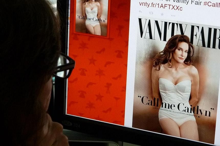 A journalist looking at Vanity Fair's Twitter site with the tweet about Caitlyn Jenner. -- PHOTO: AFP