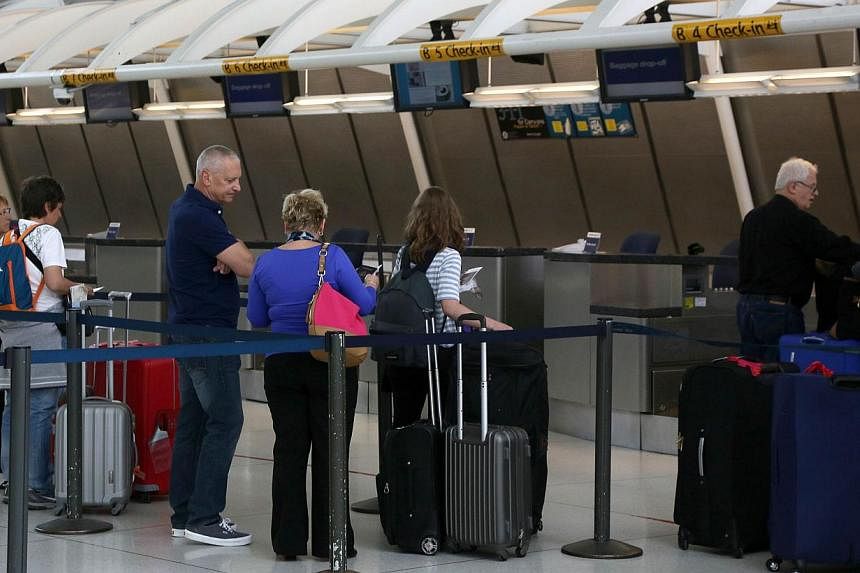 Passengers at New York's John F Kennedy Airport on May 25, 2015. US airport screeners did not detect banned weapons in 67 of 70 tests at dozens of airports, media reports said. -- PHOTO: AFP