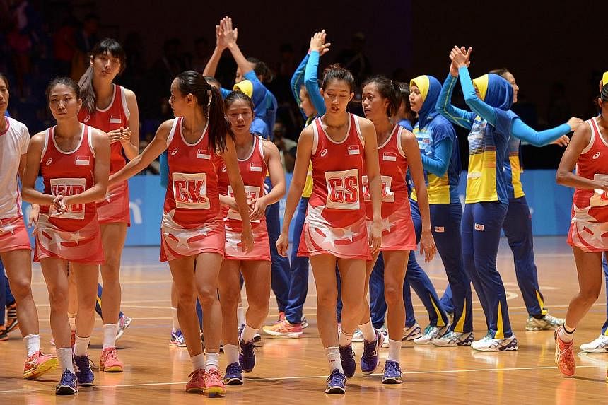 The Singapore team disconsolately walked back to their bench after the match. The hosts let a six-point lead slip in the fourth quarter against Malaysia. -- ST PHOTO: DESMOND WEE&nbsp;