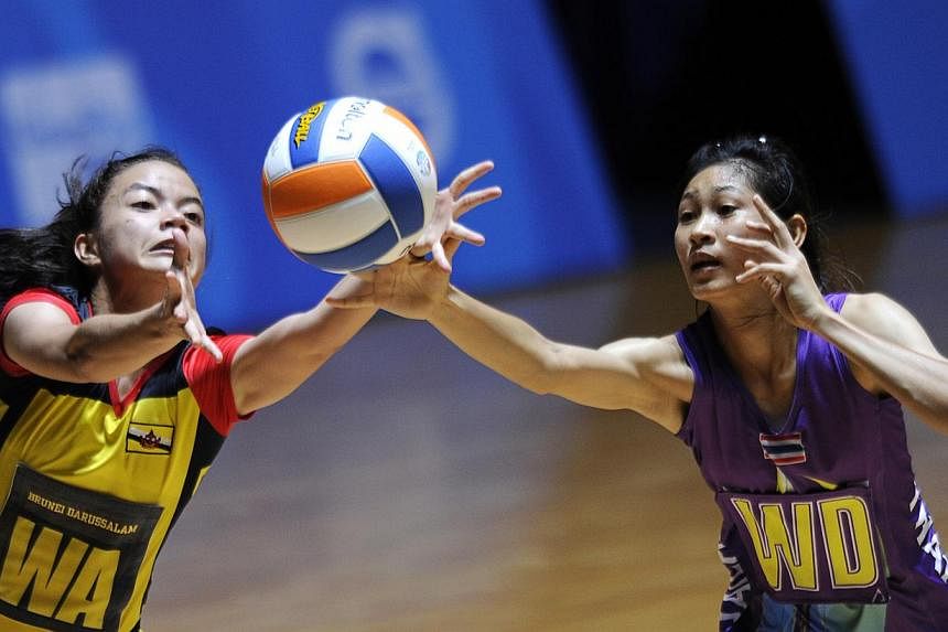 Brunei's Dk Khalisha Pg Abd Rahman (left) with Thailand's Paweena Kamwan in action at the 28th SEA Games. Brunei threatened to cause an upset against Thailand in the SEA Games netball competition on Tuesday, but ran out of steam in the end as Thailan