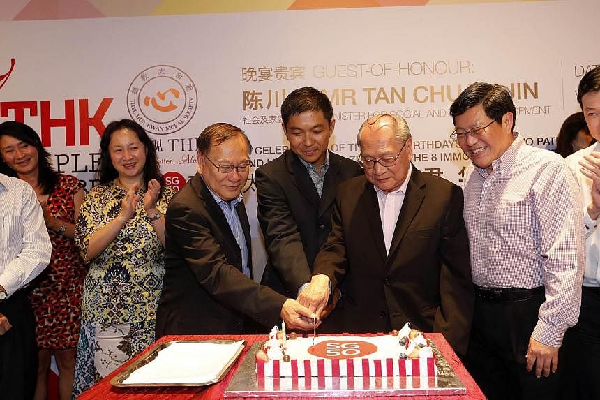 Minister for Social and Family Development, Tan Chuan-Jin (centre) cutting a cake together with Thye Hua Kwan chairman Lee Kim Siang (left) and the organisation's CEO Lee Ngak Siang, at the 37th Anniversary of Thye Hua Kwan Moral Society on Tuesday n