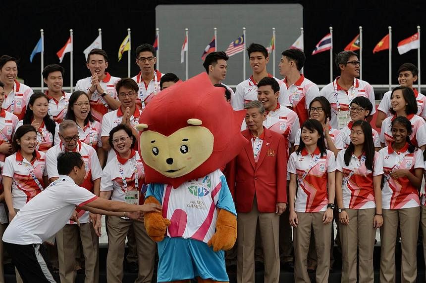 Nila, the SEA Games mascot, joins Team Singapore in a group photo after the Team Welcome ceremony on June 2, 2015. -- ST PHOTO: CAROLINE CHIA