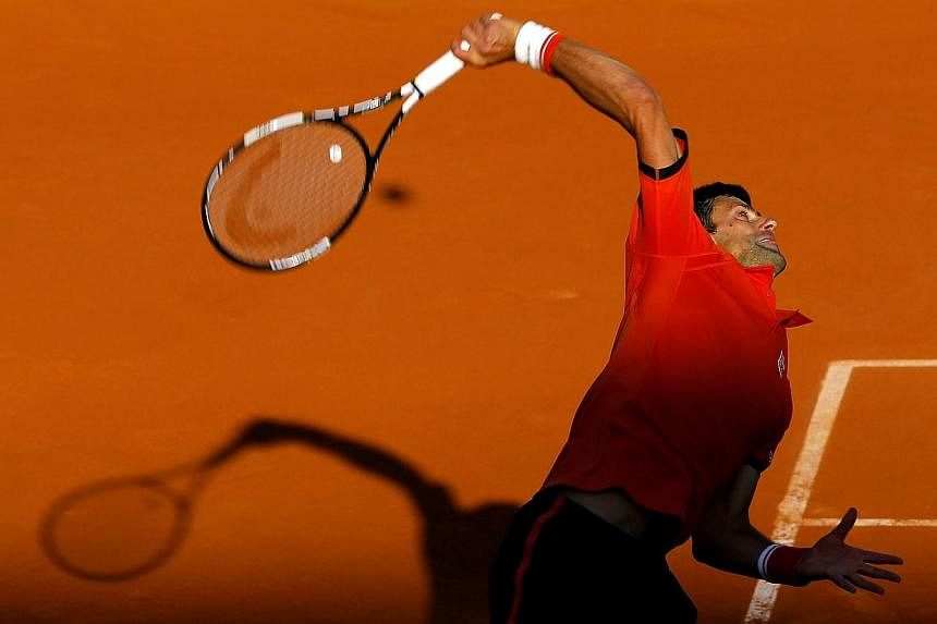 Novak Djokovic of Serbia in action against Richard Gasquet of France during their fourth round match for the French Open tennis tournament at Roland Garros in Paris on Monday (June 1). -- PHOTO: EPA