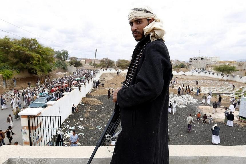 A member of Houthi militia looks on as Houthi supporters carry the coffins of comrades killed allegedly in an airstrike carried out by the Saudi-led coalition on a Houthi position in Sana’a, Yemen, -- PHOTO: EPA