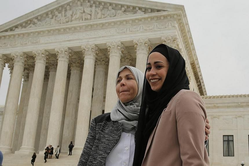 Muslim woman Samantha Elauf (right), who was denied a sales job at an Abercrombie Kids store in Tulsa in 2008, stands with her mother Majda outside the US Supreme Court in Washington, in this February 25 file photo. -- PHOTO: REUTERS