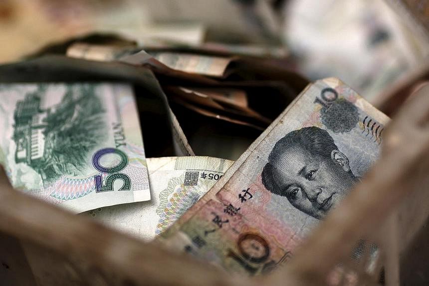 On average, Asians hold 37 per cent of their assets in their local currency, while Singaporeans hold about 33 per cent in Singapore dollars. -- PHOTO: REUTERS