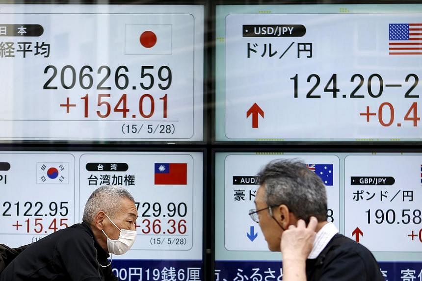 Most Asian stocks fell as Japanese shares slid on a stronger yen and investors awaited the outcome of talks between Greece and its creditors. -- PHOTO: REUTERS