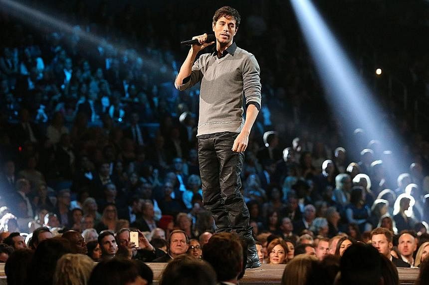Enrique Iglesias performing at the 57th Annual Grammy at the Staples Center in Los Angeles on Feb 8, 2015. Iglesias will need weeks to recover after injuries suffered from a drone during a concert turned out to be worse than feared. -- PHOTO: AFP&nbs