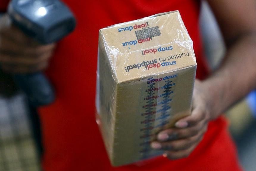 A worker of Indian e-commerce company Snapdeal.com scanning barcode on a box after it was packed at the company's warehouse in New Delhi on April 20, 2015. -- PHOTO: REUTERS