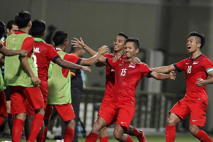 Singapore's under-23 defender Sheikh Abdul Hadi Sh Othman (No.15) celebrating with his teammates after scoring the goal against the Philippines at the 28th Sea Games held at the Jalan Besar Stadium on June 1,&nbsp;2015.&nbsp;Singapore's coach Aide Is