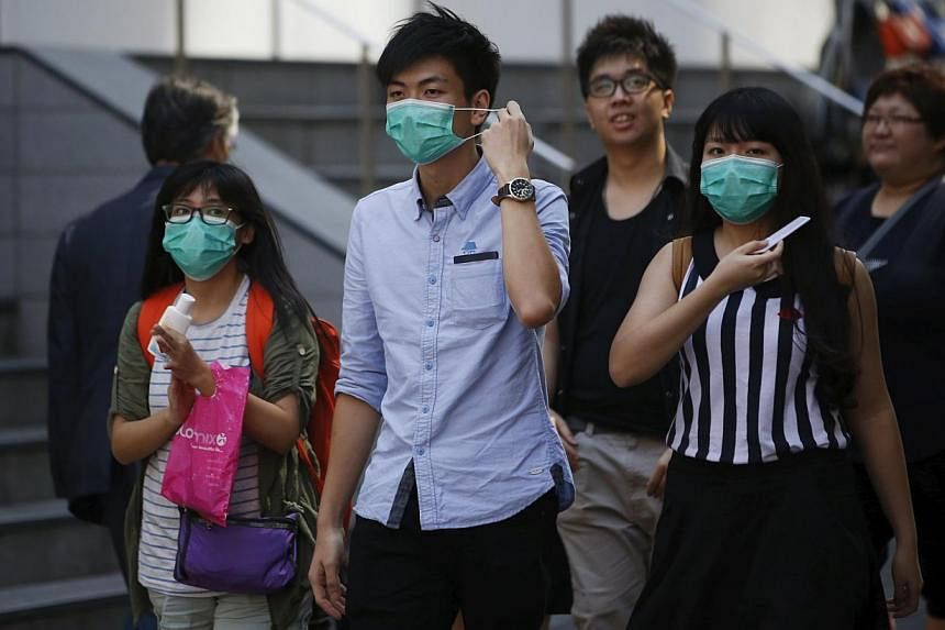 Tourists wearing masks to prevent contracting Middle East Respiratory Syndrome (Mers), walk at Myeongdong shopping district in central Seoul, South Korea on June 3, 2015. -- PHOTO: &nbsp;REUTERS