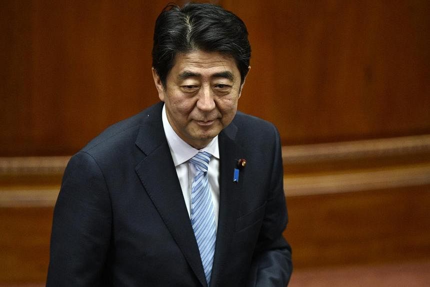 Japanese Prime Minister Shinzo Abe's ruling party called for a "cautious response" to the China-led Asian Infrastructure Investment Bank (AIIB), but will leave the decision on joining to the premier, a draft report shows on Wednesday. -- PHOTO: EPA