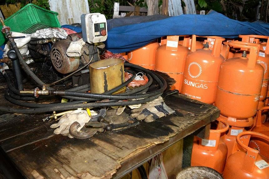 &nbsp;A makeshift factory suspected to be illegally refilling LPG (liquefied petroleum gas) canisters was discovered in a forest clearing in Seletar West on June 2, 2015. -- PHOTO: SHIN MIN&nbsp;