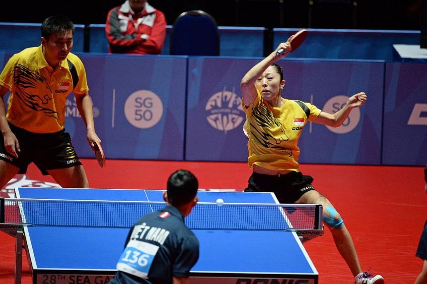 Singapore's Yu Mengyu and Yang Zi ( left ) playing against Vietnam in the semi final of the mixed doubles.&nbsp;-- ST PHOTO: DESMOND FOO&nbsp;