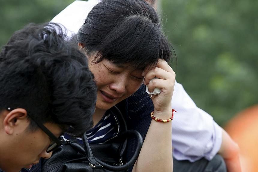 A relative of a passenger of the sunken cruise ship cries on a road to the site of the sinking in the Jianli section of Yangtze River, Hubei province, China, on June 3, 2015.&nbsp;More than 200 divers combed a capsized Chinese ship in the Yangtze Riv