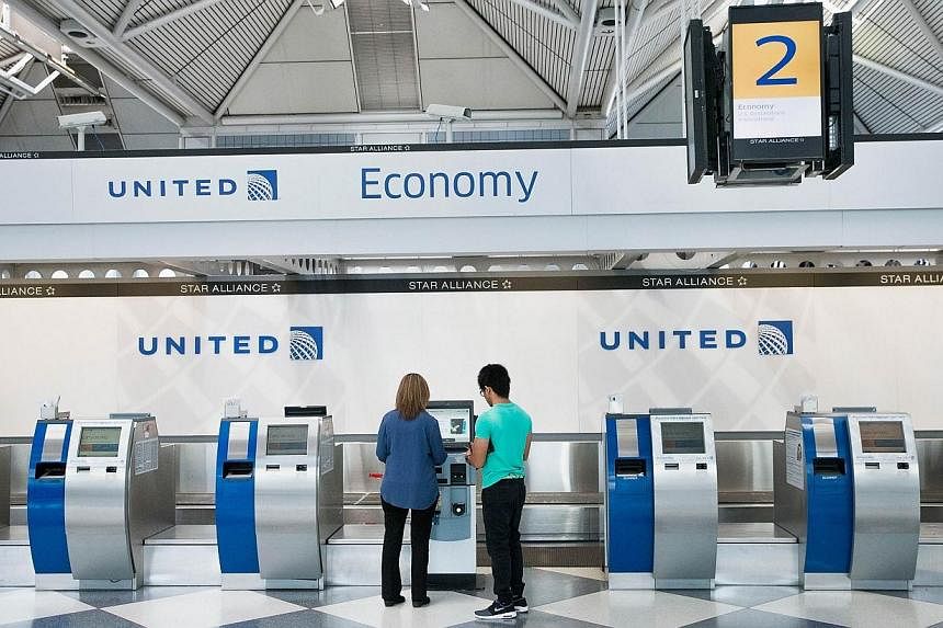Passengers check-in for flights with United Airlines at O'Hare Airport on Tuesday in Chicago, Illinois. United travelers experienced widespread delays this morning after the airline was forced to ground flights after reports of bomb threats being mad