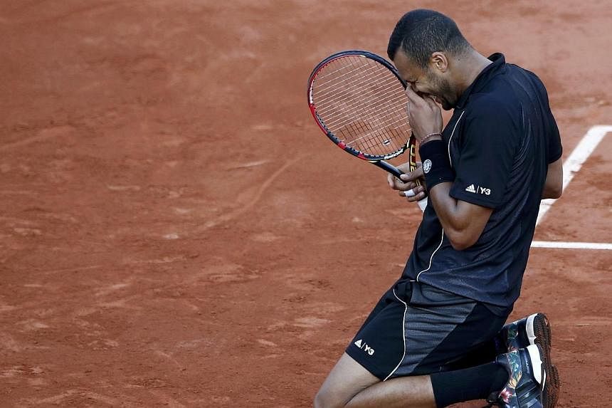 Jo-Wilfried Tsonga of France celebrates after defeating Kei Nishikori of Japan during their men's quarter-final match during the French Open tennis tournament at the Roland Garros stadium in Paris. PHOTO: REUTERS