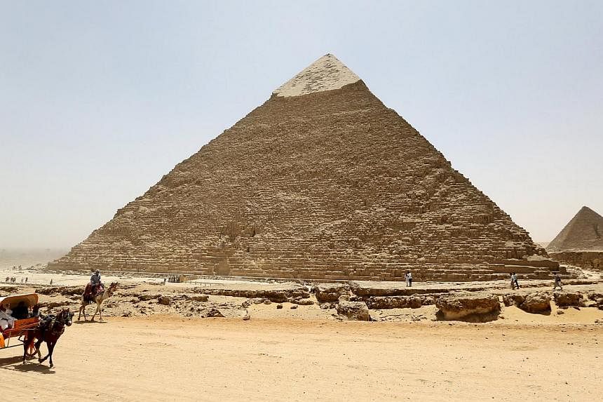 Gunmen on a motorbike Wednesday killed two Egyptian policemen who worked as guards at the world-famous Giza pyramids in Cairo, in the latest attack on security forces, police said. -- PHOTO: REUTERS&nbsp;