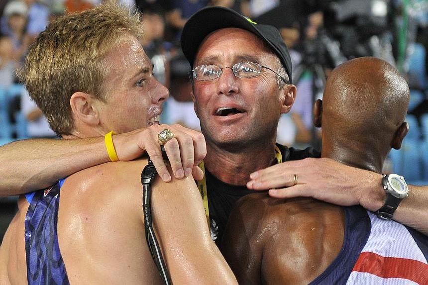 A photograph taken on Sept 4, 2011, shows US coach Alberto Salazar (centre) hugging US athlete Bernard Lagat (right) and US athlete Galen Rupp following the men's 5,000 metres final at the International Association of Athletics Federations (IAAF) Wor