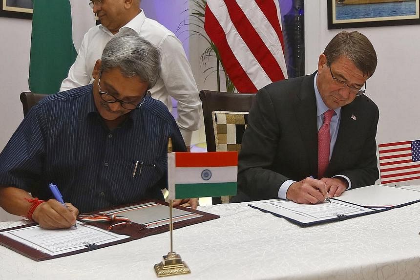 US Defence Secretary Ashton Carter (right) and India's Defence Minister Manohar Parrikar at the signing of agreements ceremony in New Delhi, India, on June 3, 2015. -- PHOTO: REUTERS