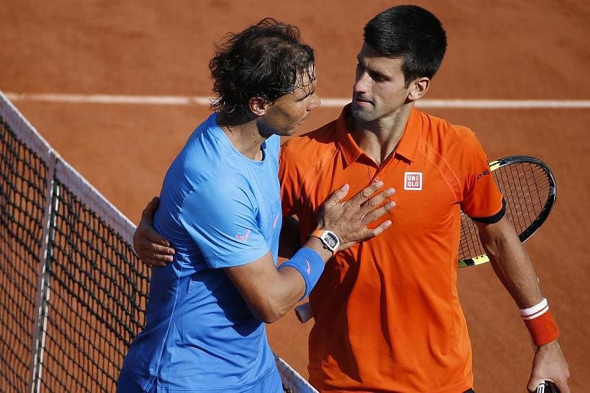 Spain's Rafael Nadal (left) shakes hands with Serbia's Novak Djokovic at the end of their men's quarter final match of the Roland Garros 2015 French Tennis Open in Paris on June 3, 2015. -- PHOTO: AFP