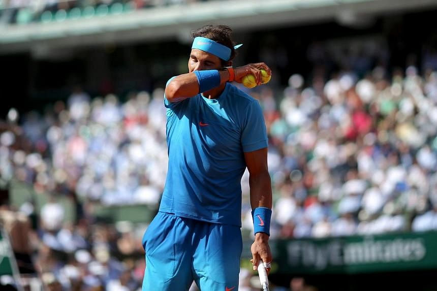 Rafael Nadal of Spain in action against Novak Djokovic of Serbia during their quarterfinal match for the French Open tennis tournament at Roland Garros in Paris, France, on June 3, 2015. -- PHOTO: EPA