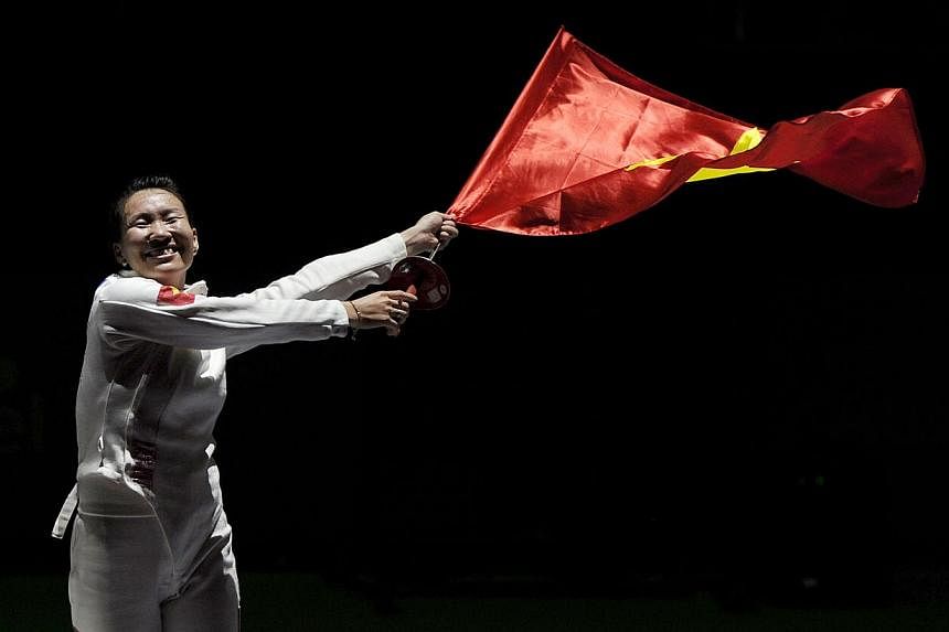 Vietnam's Tran Thi Len celebrates winning the womens individual Epee final, beating Harlene Raguin from the Philippines 11-7. -- PHOTO: REUTERS &nbsp;