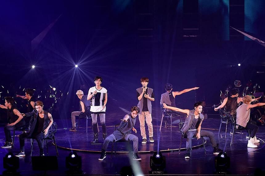 Popular K-pop boy band EXO performing at the Singapore Indoor Stadium during their first concert in Singapore. -- PHOTO: THE NEW PAPER FILE
