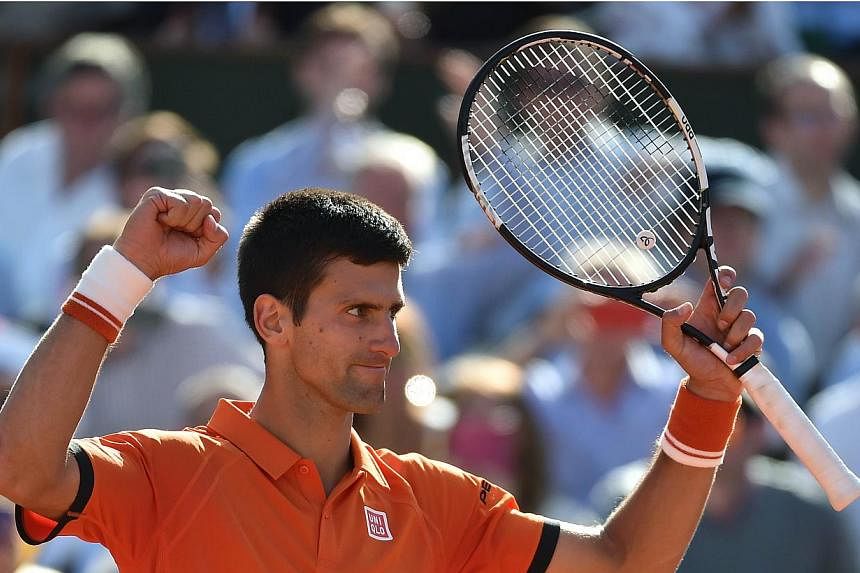 Serbia's Novak Djokovic celebrates his victory over Spain's Rafael Nadal at the end of their men's quarter final match of the Roland Garros 2015 French Tennis Open in Paris on June 3, 2015. -- PHOTO: AFP &nbsp;