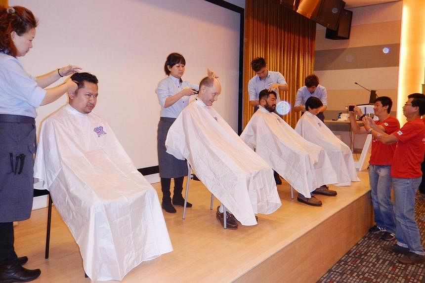 (From left) Mr Khairul Akram, Mr Timothy Goodchild, Mr Poo Chun Yong and Ms Cheong Sook Han take part in the Children’s Cancer Foundation’s (CCF) Hair for Hope effort on June 5, 2015. -- PHOTO: STARHUB &nbsp;