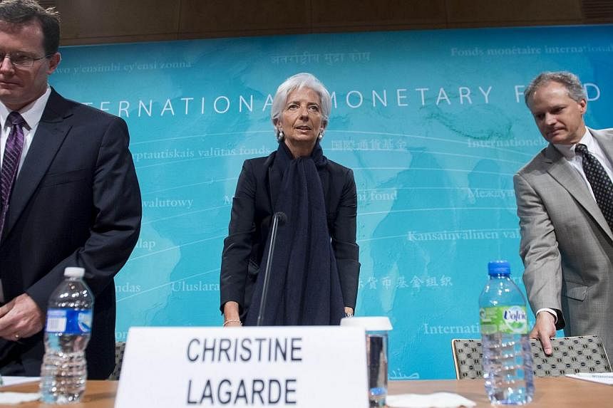 US Mission Chief Nigel Chalk (left), IMF Managing Director Christine Lagarde (centre) and Western Hemisphere Director Alejandro Werner at a press conference at IMF Headquarters in Washington, DC, on June 4, 2015. -- PHOTO: AFP&nbsp;