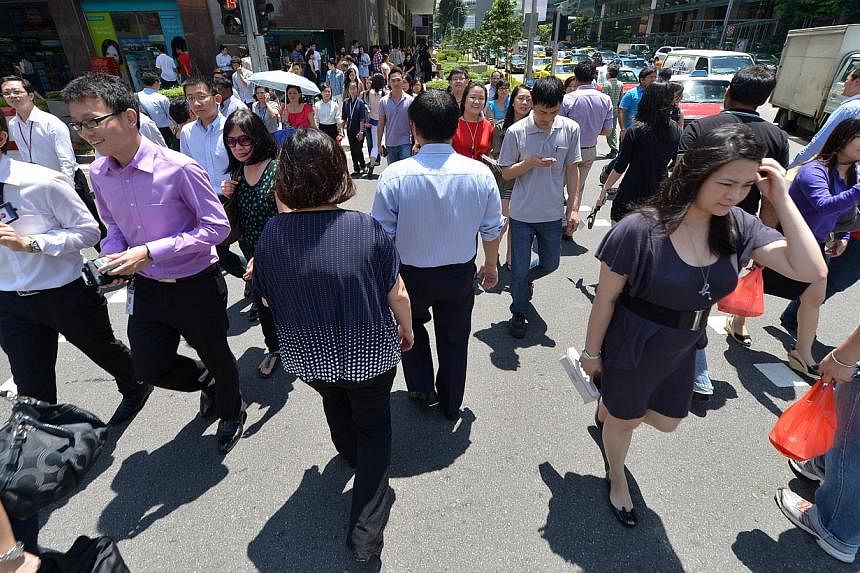 Salaries in the private sector grew by 4.9 per cent last year, down from 5.3 per cent the previous year, amid slower economic growth. -- PHOTO: ST FILE