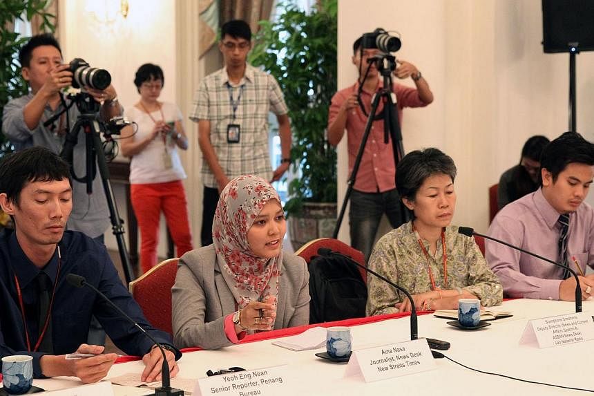 The visiting Asean journalists responding to PM Lee during their interview with him at the Istana on June 4, 2015. -- PHOTO: MCI