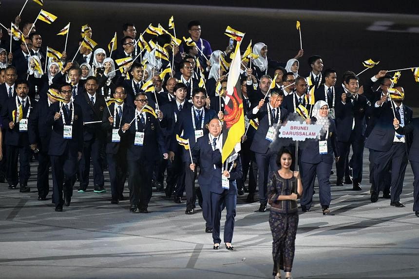 Athletes from Brunei marching into the National Stadium during the SEA Games opening ceremony on June 5, 2015. -- PHOTO: AFP&nbsp;