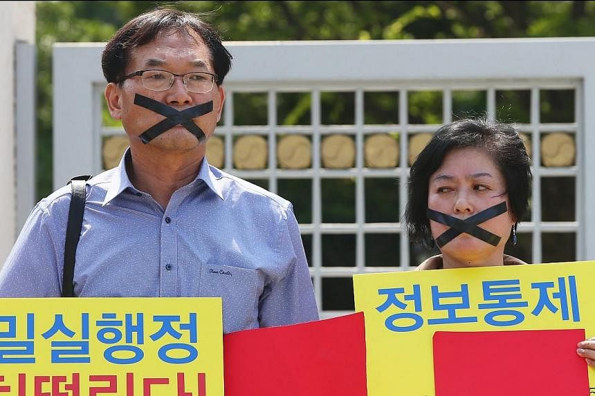 South Korean protesters hold placards reading 'Total incompetence of the government for sluggish response' and show red cards during a rally against government's health policy in Seoul, South Korea on Thursday (June 4). MERS, or the Middle East Respi
