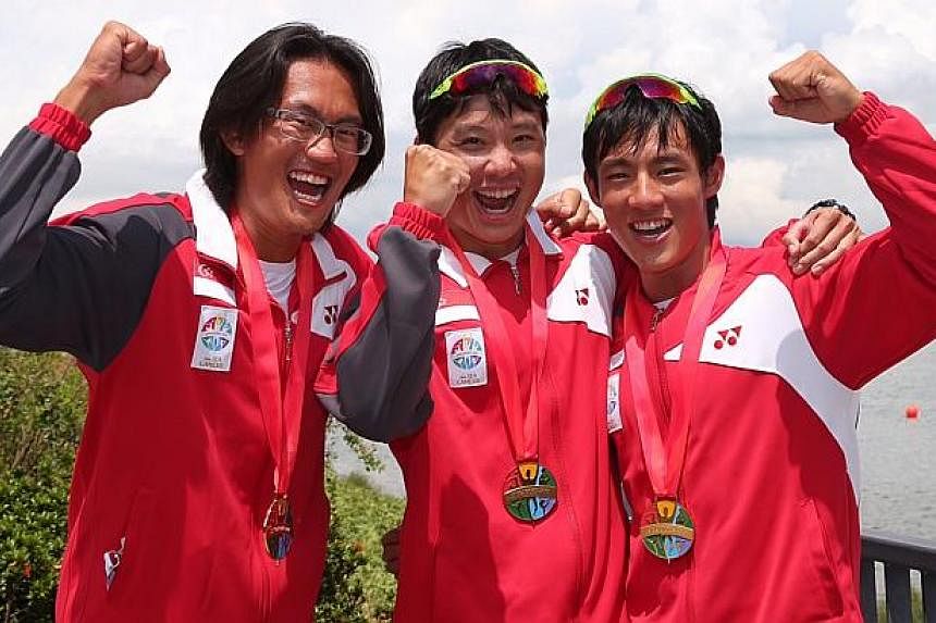 (From left) Gold medalists Lucas Teo, Bill Lee and Brandon Ooi with their medals. -- ST PHOTO: NEO XIAOBIN