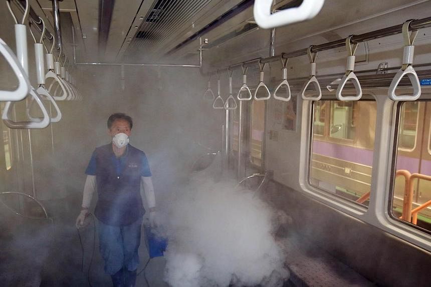 A subway train carriage in Seoul being disinfected on Thursday. The outbreak of Middle East respiratory syndrome in South Korea has claimed a fourth life and the number of confirmed cases has risen to 42.
