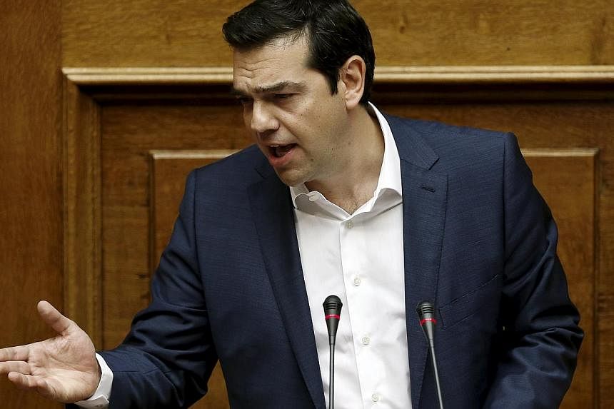Greek Prime Minister Alexis Tsipras delivers a speech during a parliamentary session to brief lawmakers over the ongoing talks with the country's lenders, in Athens, Greece, on June 5, 2015. The Greek PM said that the country was "closer than ever to