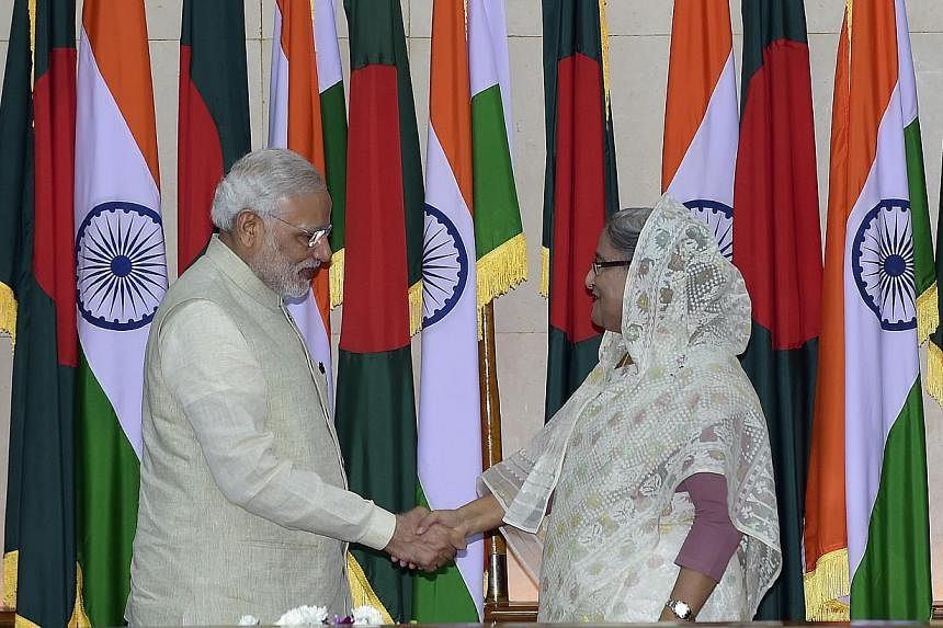 Indian Prime Minister Narendra Modi (left) shakes hand with Bangladeshi Prime Minister Sheikh Hasina Wajid after their meeting at the Prime Minister's Office in Dhaka on June 6, 2015. The two neighbours signed a historic pact on Friday&nbsp;to simpli
