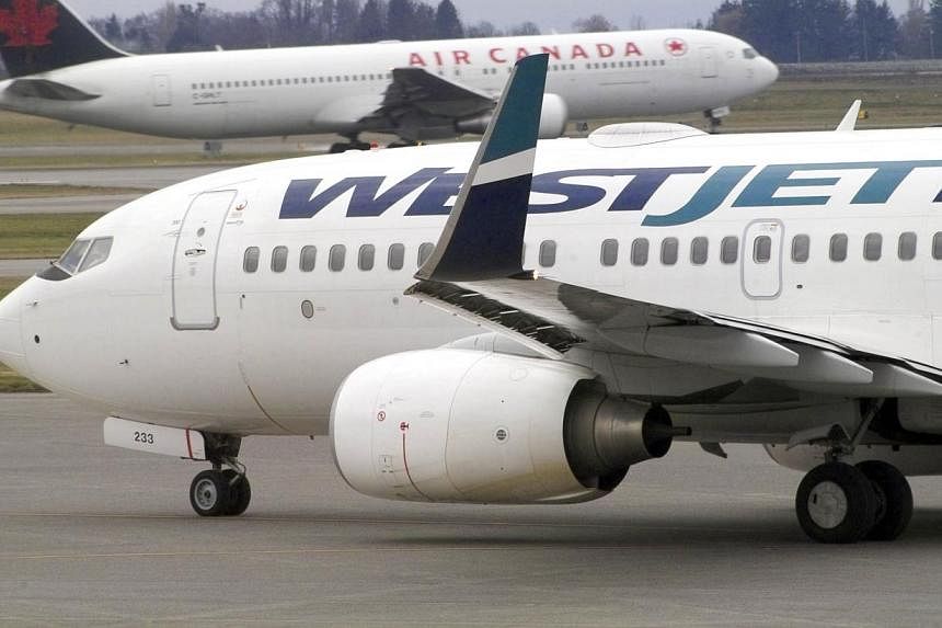 A Canadian domestic Westjet flight from Toronto skidded off the end of a runway at Montreal airport during a thunderstorm on Friday, June 5, 2015, but no injuries were reported. -- PHOTO: BLOOMBERG