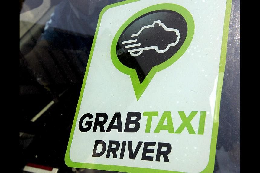 Transport app provider GrabTaxi is tying up with a rental company to grow a fleet of on-call taxis.&nbsp;-- PHOTO: ST FILE