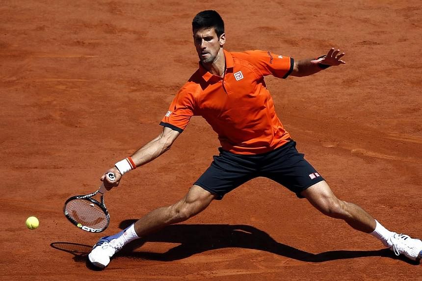 Novak Djokovic of Serbia in action against Andy Murray of Britain during their semifinal match for the French Open tennis tournament at Roland Garros in Paris, France on June 6, 2015. -- PHOTO: EPA